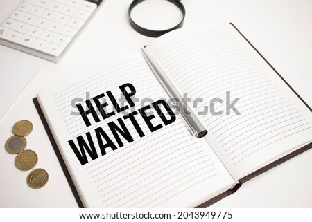 Business accessories, calculator, coins, reports and magnifier glass with text Help Wanted