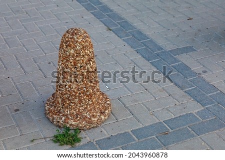 Stone cone in the urbanism of the city and urban environment. Background with copy space for text or inscriptions.