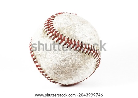 A used baseball photographed in a light box 