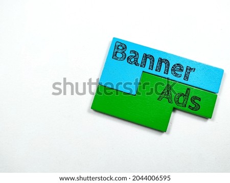 Business concept.Text Banner Ads writing on colored wooden puzzle on white background.
