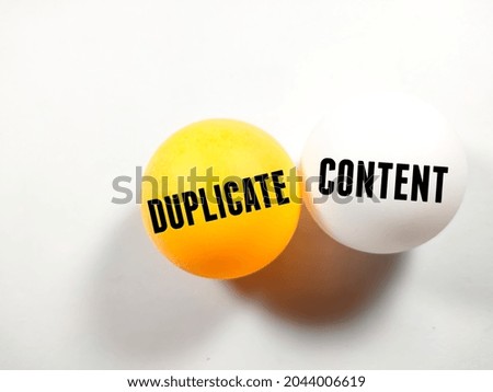 Business concept.Text DUPLICATE CONTENT writing on ping pong ball on white background. Royalty-Free Stock Photo #2044006619