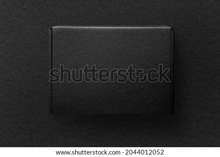 Kraft paper black box product packaging with design space flat lay Royalty-Free Stock Photo #2044012052