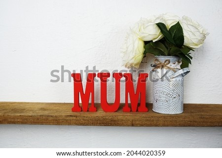MUM alphabet letter on wooden background