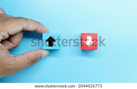 colored wooden cubes with down and up arrow icons