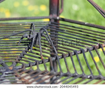 handicraft - a handmade steel spider, guards the place for the fire - the grate is his cobweb
