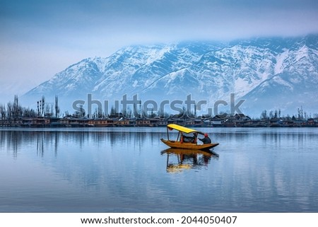 A view of Dal Lake in winter, and the beautiful mountain range in the background in the city of Srinagar, Kashmir, India. Royalty-Free Stock Photo #2044050407