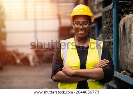 Portrait Black smart African women worker standing happy smiling in factory industry workplace Royalty-Free Stock Photo #2044056773