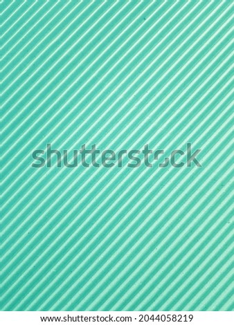 Diagonal green corrugated paper background. (closeup)
With copy space.