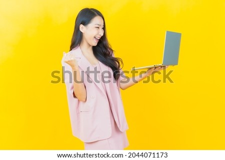 Portrait beautiful young asian woman smile with computer laptop on isolated background
