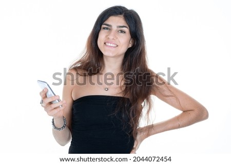 young woman with long hair brunette holding a phone smartphone in hand