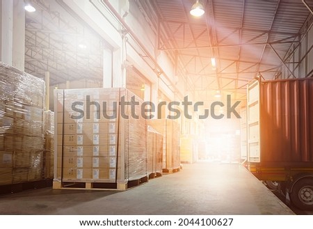 Stacked of Package Boxes on Pallets Loading with Shipping Cargo Container. Truck Parked Loading at Dock Warehouse. Delivery. Supply Chain. Warehouse Logistics. Cargo Freight Truck Transportation.	 Royalty-Free Stock Photo #2044100627