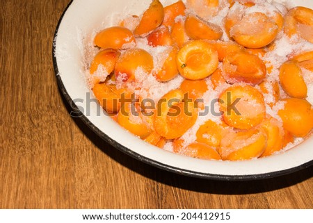 Cooking apricot jam in a pan in the kitchen in the village