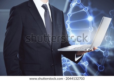 Headless businessman standing in blurry office interior with glowing DNA hologram. Bio engineering concept. Double exposure