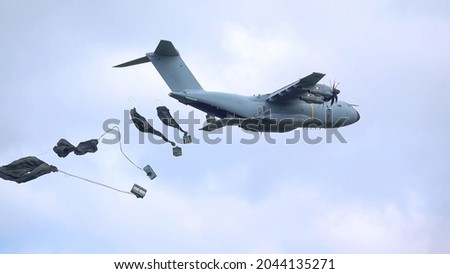 ZM401 RAF Royal Air Force Airbus A400M Atlas military cargo plane on a low-level cargo parachute drop exercise, blue sky light cloud Royalty-Free Stock Photo #2044135271