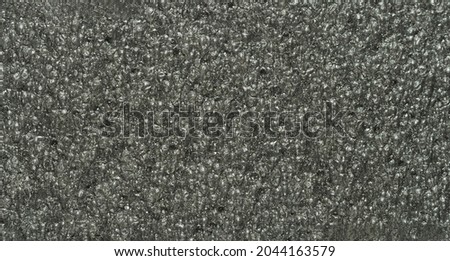 close up, background, texture, large long horizontal banner. surface structure black expanded polyethylene, EPE, padding cushioning material for packages. full depth of field. high resolution photo