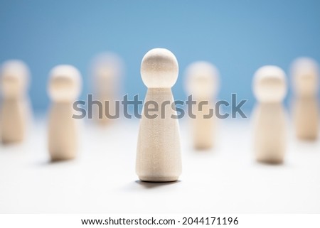 Wooden business team with one person standing out from the crowd concept for leadership or individuality Royalty-Free Stock Photo #2044171196