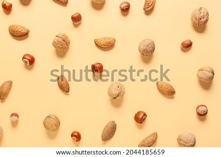 Different healthy nuts on color background Royalty-Free Stock Photo #2044185659