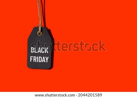 Black friday tag isolated on red background with copy space