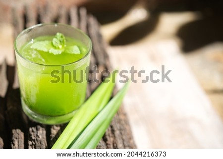 Pandan Juice with green pandan leaves on wooden Royalty-Free Stock Photo #2044216373