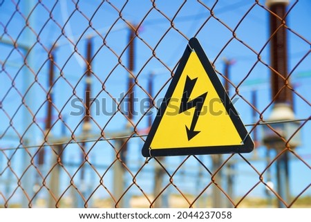 Electrical hazard sign placed on a metal fence.