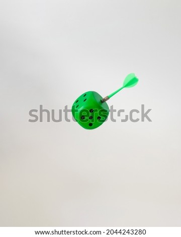 dice green with stabbed arrow.concept design.white background.flying object