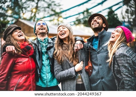 Milenial friends group walking at London city center - Next generation friendship concept on multi-cultural young people wearing winter fashion clothes having fun together outside - Warm vivid filter Royalty-Free Stock Photo #2044249367