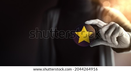 Success in Business or Personal Talent Concept. Young Employee Woman Holding a Golden Star Royalty-Free Stock Photo #2044264916