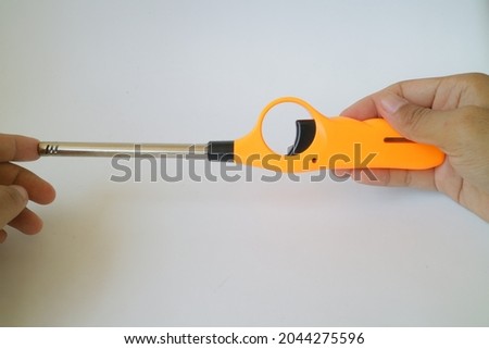 orange color of long neck gas lighter photo