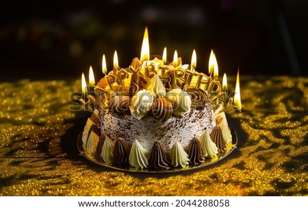 Happy birthday cake with candles, lights bokeh background