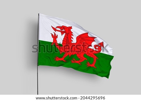 Wales flag isolated on white background. Close up waving flag of Wales. Concept of Welsh.