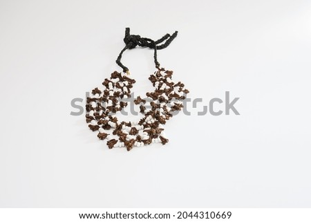 handmade necklace made of clove seeds. isolated white background