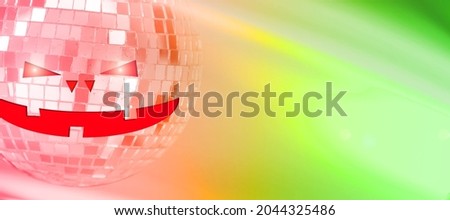 mirror ball with halluin face on colored background with highlights. High quality photo