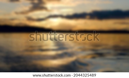lake at sunset. blurred image. background for design. High quality photo