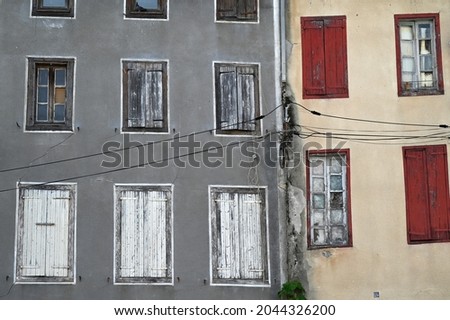 Facades of abandoned buildings in Castelnaudary  Royalty-Free Stock Photo #2044326200