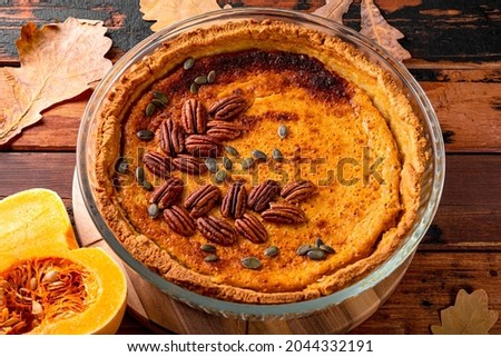  Traditional American pumpkin pie with pecans, homemade pumpkin pie on the old wooden background, pumpkin baked