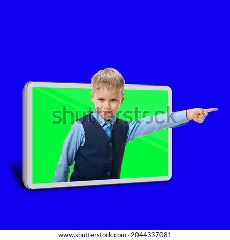 Schoolboy using digital tablet for learning online from home concept, blue chroma key on the background and green in the smart device
