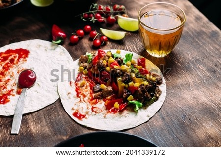 Tacos with meat and vegetables. Cooking tacos