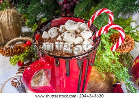 Homemade hot chocolate with mini marshmallows, hot cozy Christmas cocoa drink on wooden background with Xmas decorations copy space