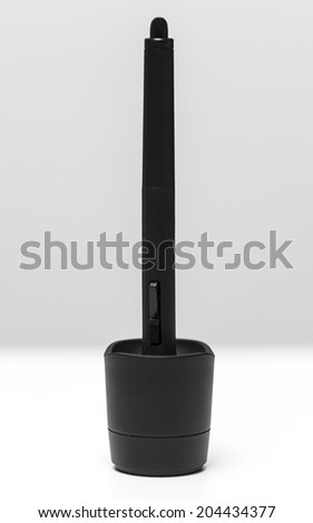 Closeup of graphic tablet pen in holder on white background