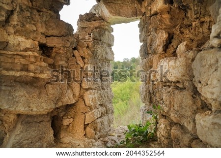 opening in the fortress and the old wall of stones