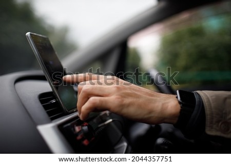 Navigator in car vehicle transportation commuter. Driver man using mobile phone navigator app while driving car vehicle Royalty-Free Stock Photo #2044357751