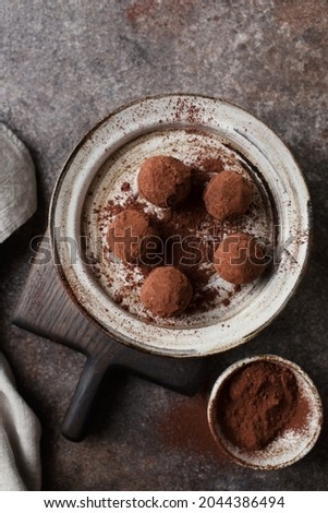 Chocolate candies. Delicious dessert on a brown background. Chocolate truffles in cocoa. Macro photography of sweets. Close-up of the candy. Space for text