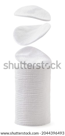 Cotton pads fall on the pile close-up on a white background. Isolated Royalty-Free Stock Photo #2044396493