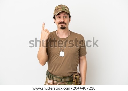 Soldier man isolated on white background pointing with the index finger a great idea