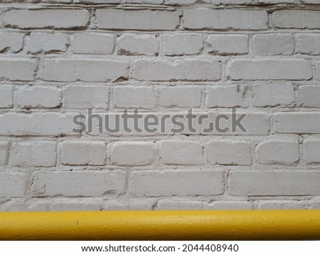 white wall with a bright yellow chimney
