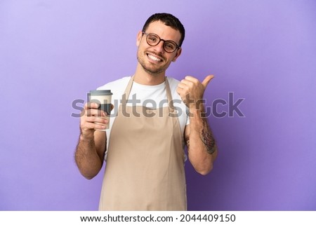 Brazilian restaurant waiter over isolated purple background with thumbs up gesture and smiling