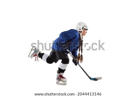 Shot on goal, stickhandling. Full-length portrait of young girl playing hockey. Child holding stick, wearing helmet. Competition training. Winning goals. Concepth of childhood, sport, strength ad