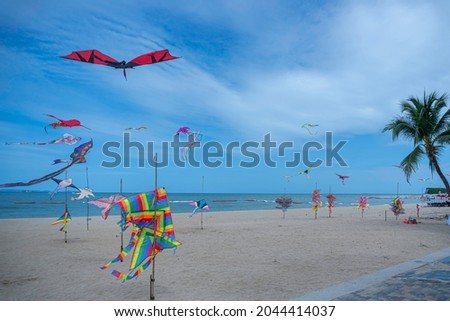 A beach on the Gulf of Thailand coast of Asia full of kites on the white sand beach of Pattaya.