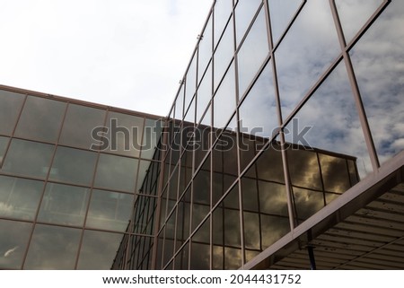Modern glass wall in steel structure on a business building for background.