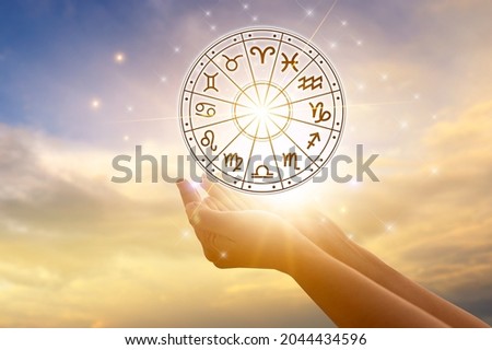 Zodiac signs inside of horoscope circle astrology and horoscopes concept Royalty-Free Stock Photo #2044434596